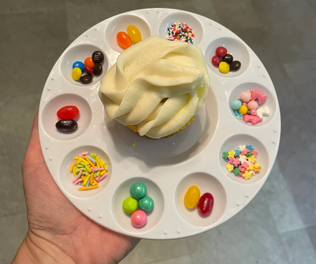 A cupcake with candies around it