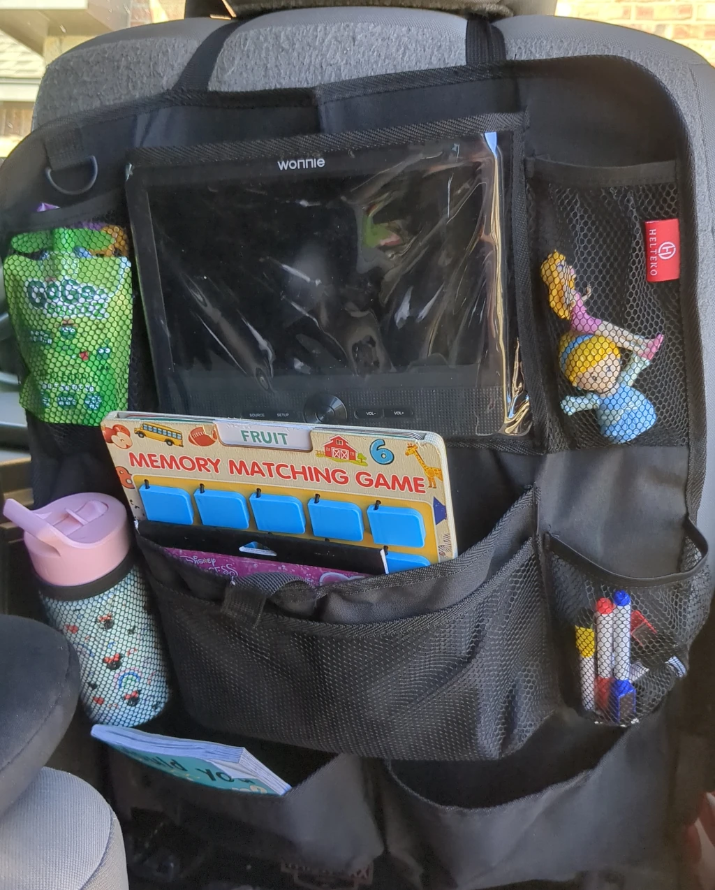 An organizer that fits behind a car seat