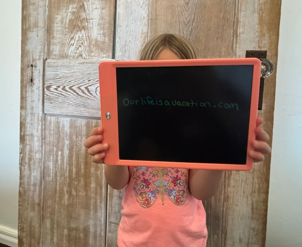 A girl holding a writing tablet