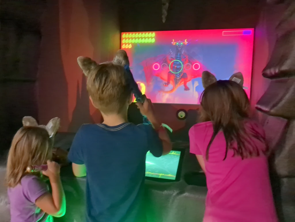 Kids playing a game where they fight a dragon