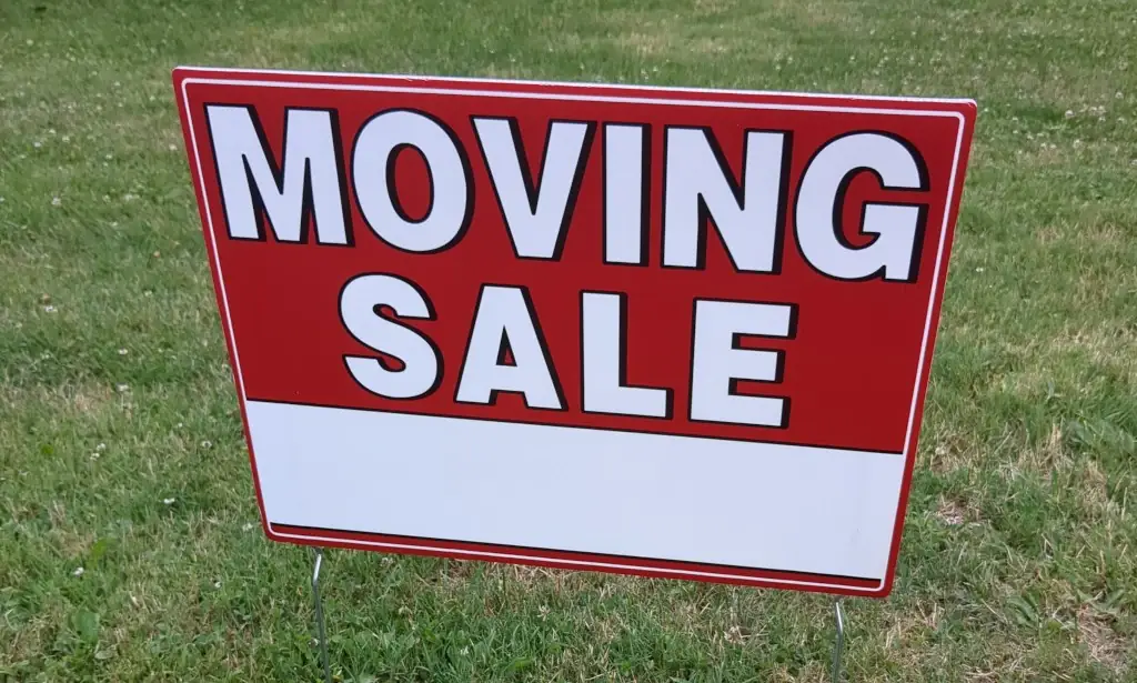 A yard sign that says 'moving sale'