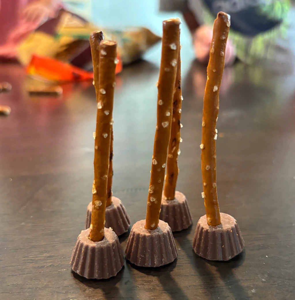 Pretzel sticks and Reese Cups that look like brooms