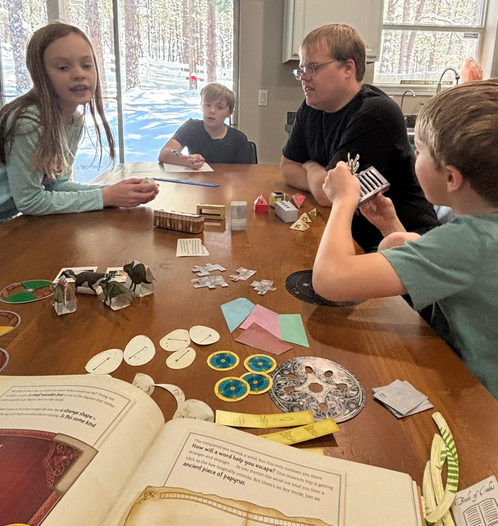 Kids and their dad gathered around a table