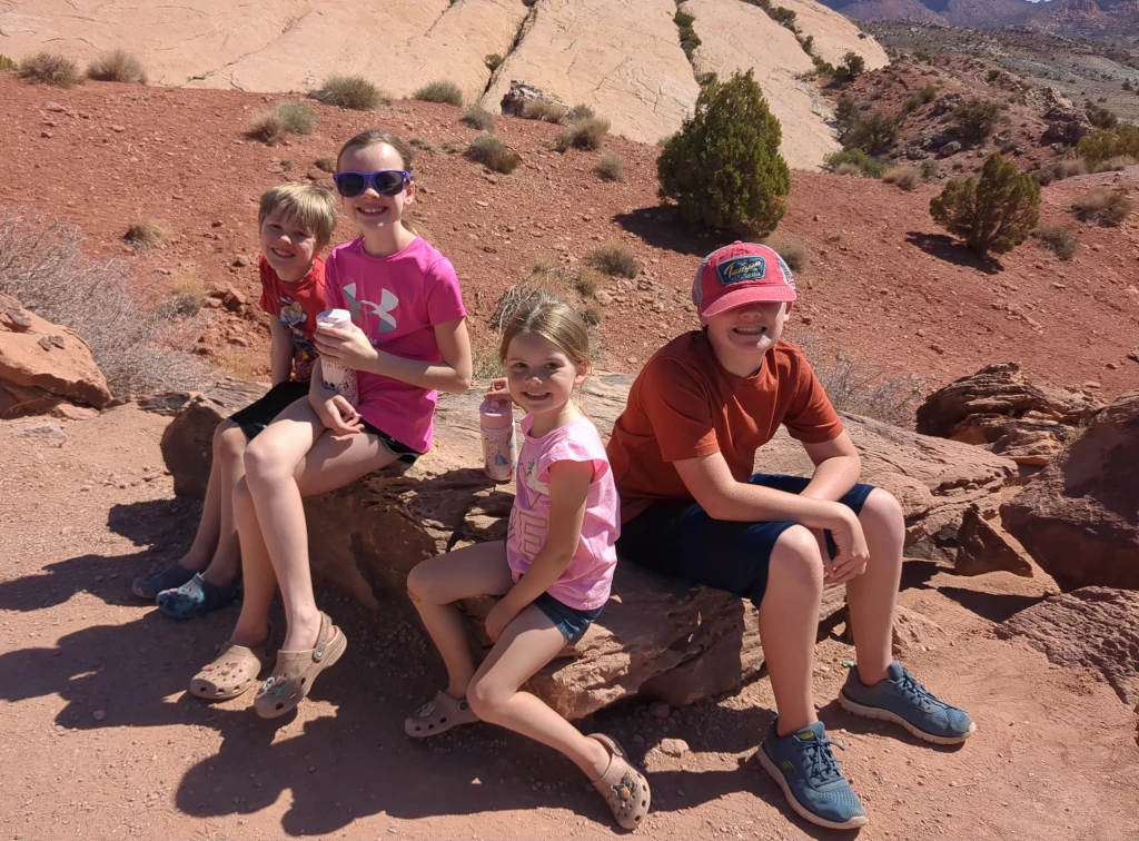 Kids sitting on a rock after hiking