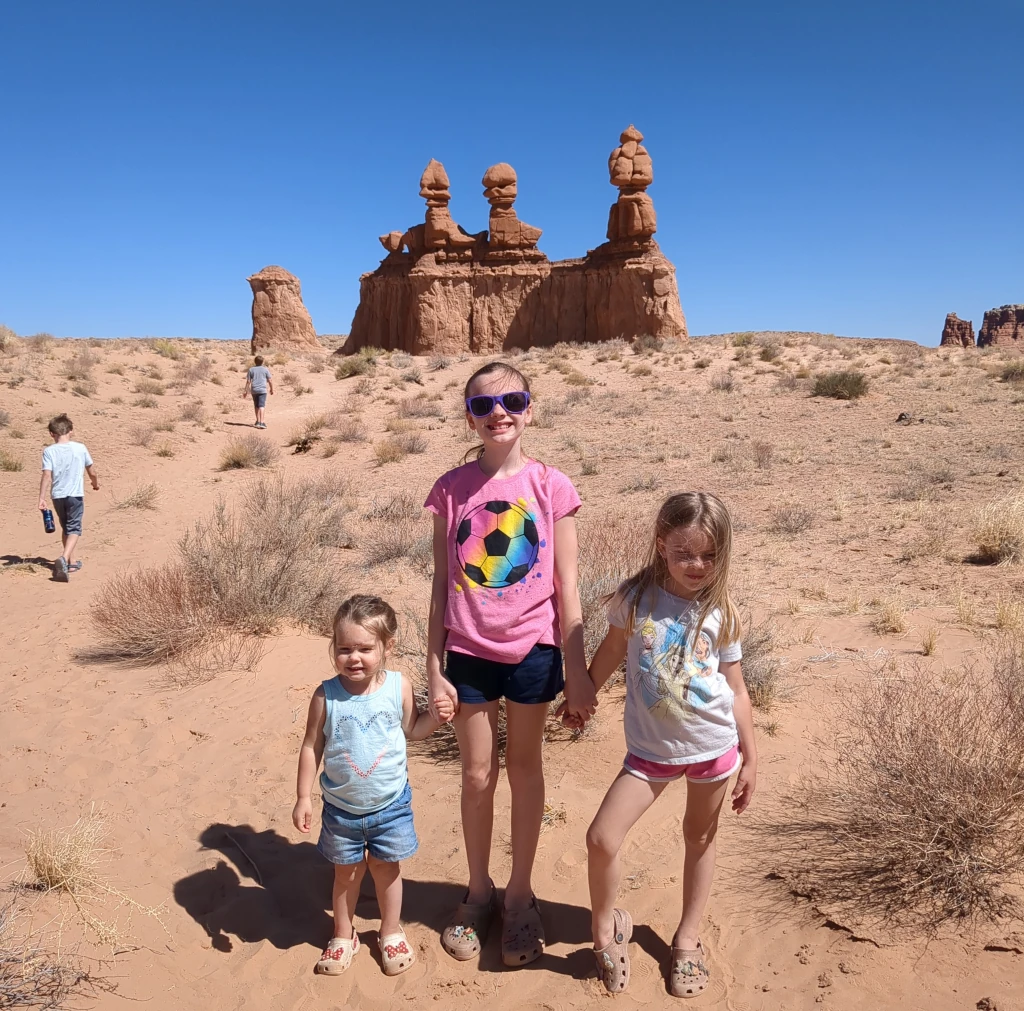 Kids posing in front of 3 rock formations