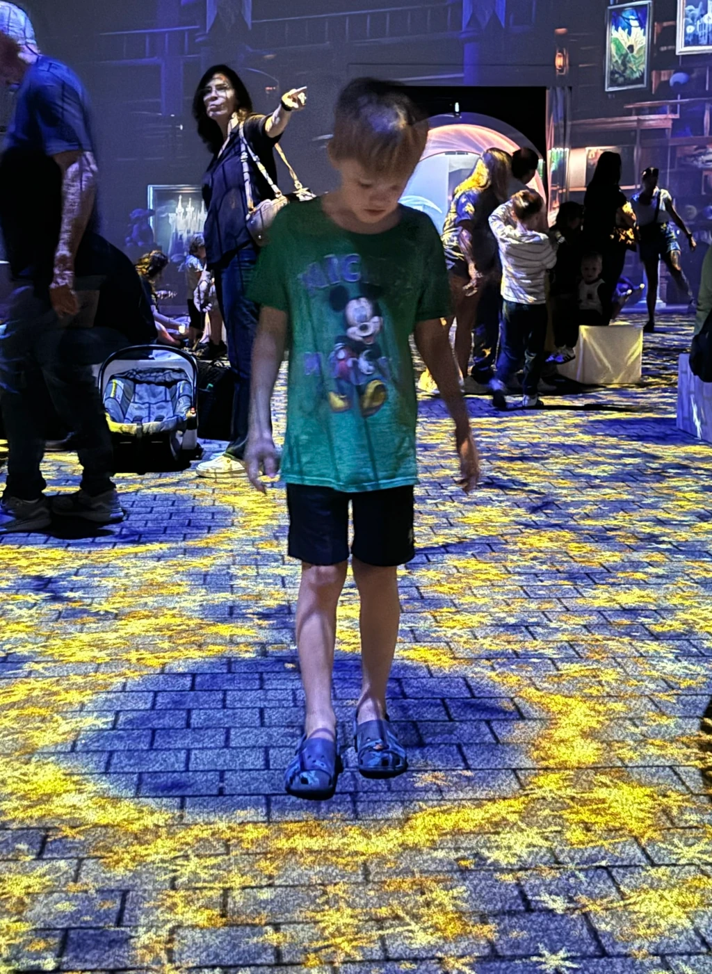 A boy standing on a floor made of stars