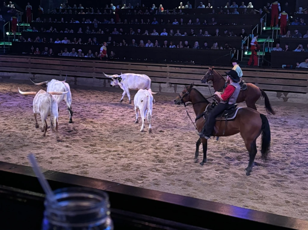 Two cowboys herding some cows