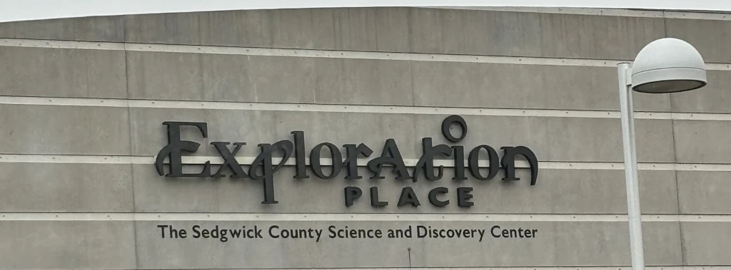 A sign on a building that says 'Exploration Place'