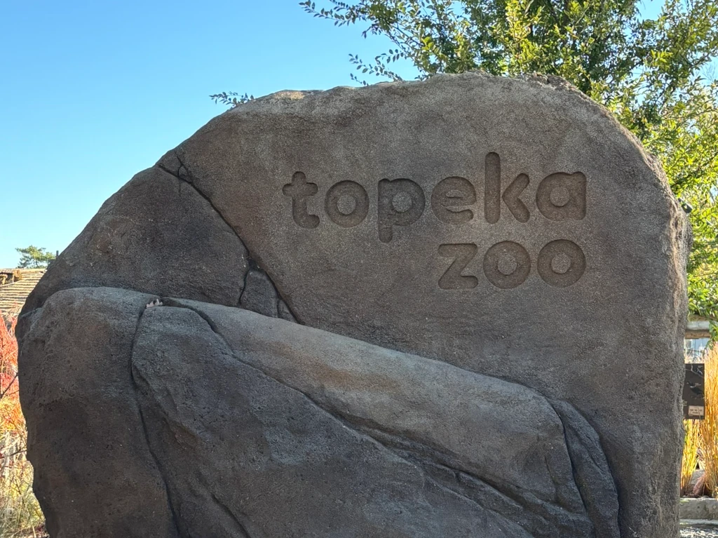 A rock with the words 'Topeka Zoo' carved in it