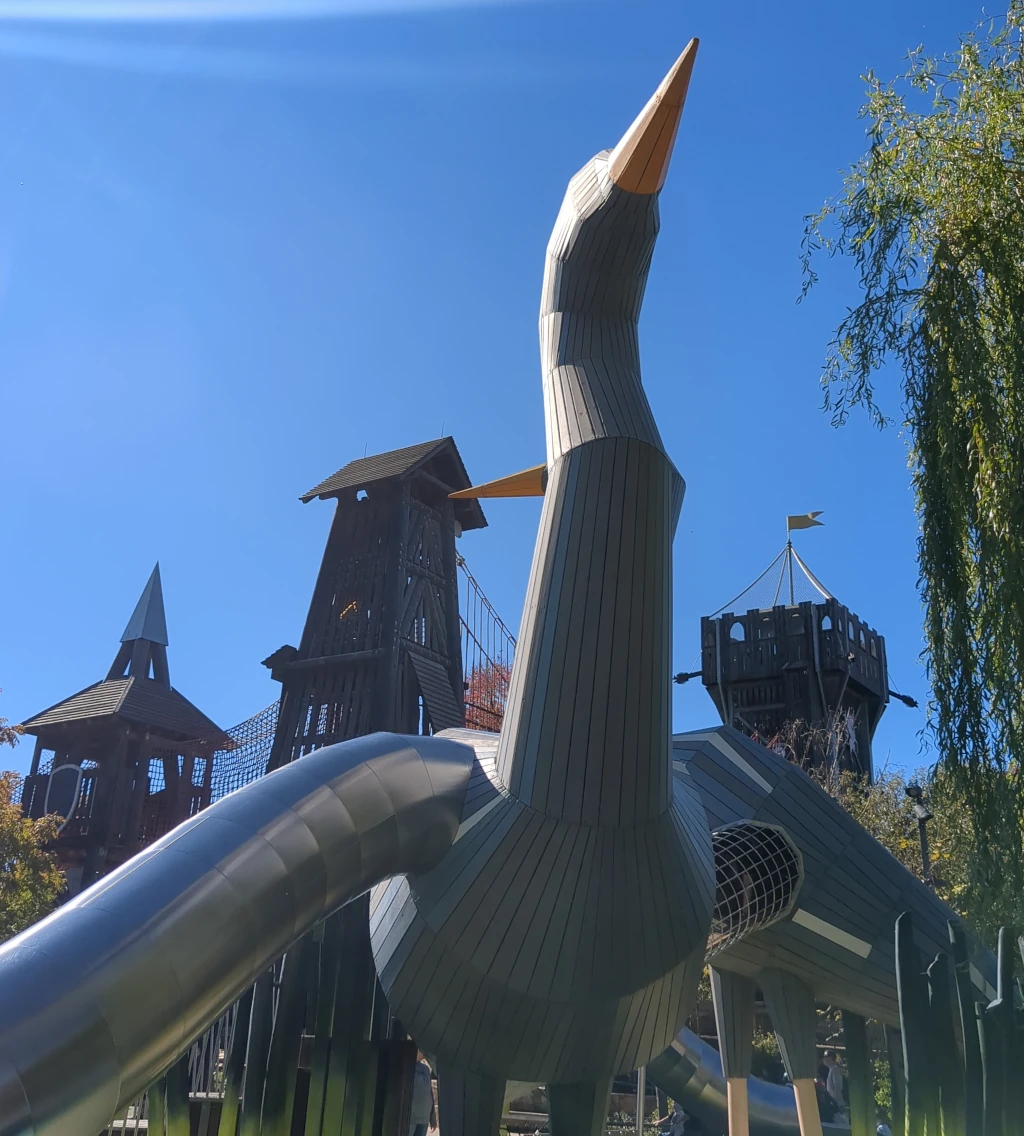 A large metal swan with slides inside