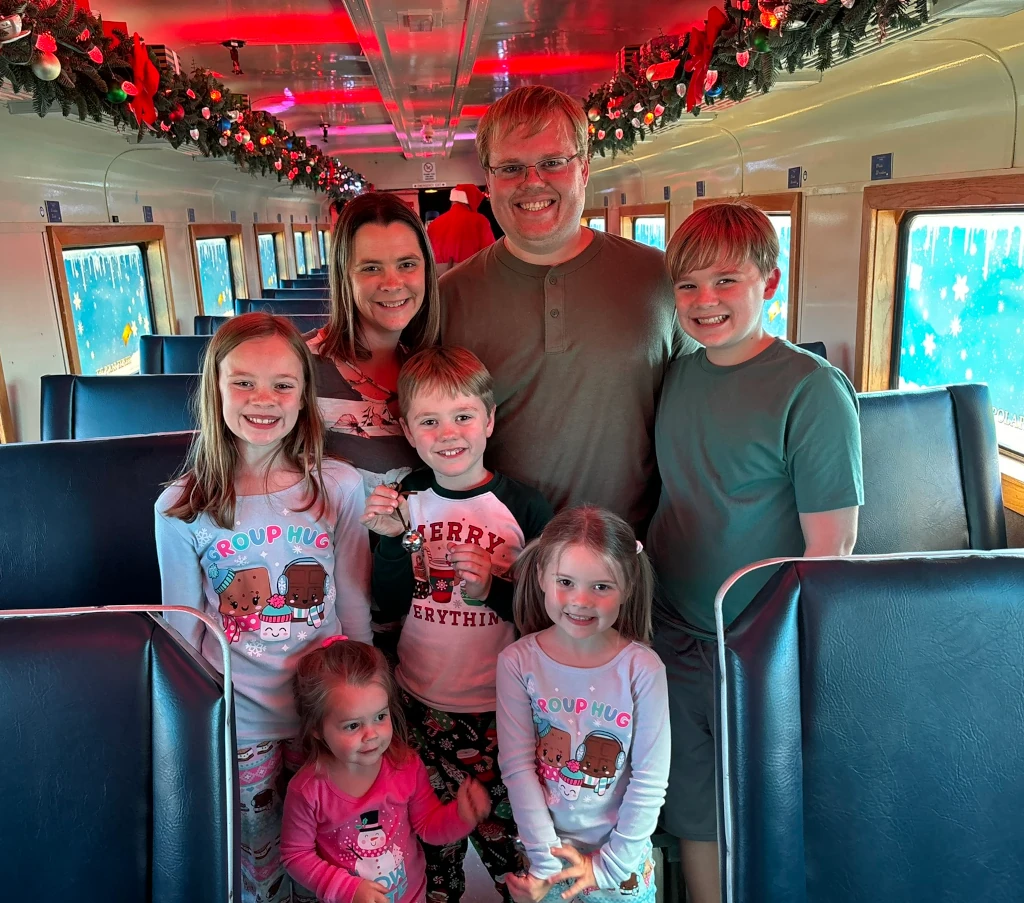 A family posing on a train