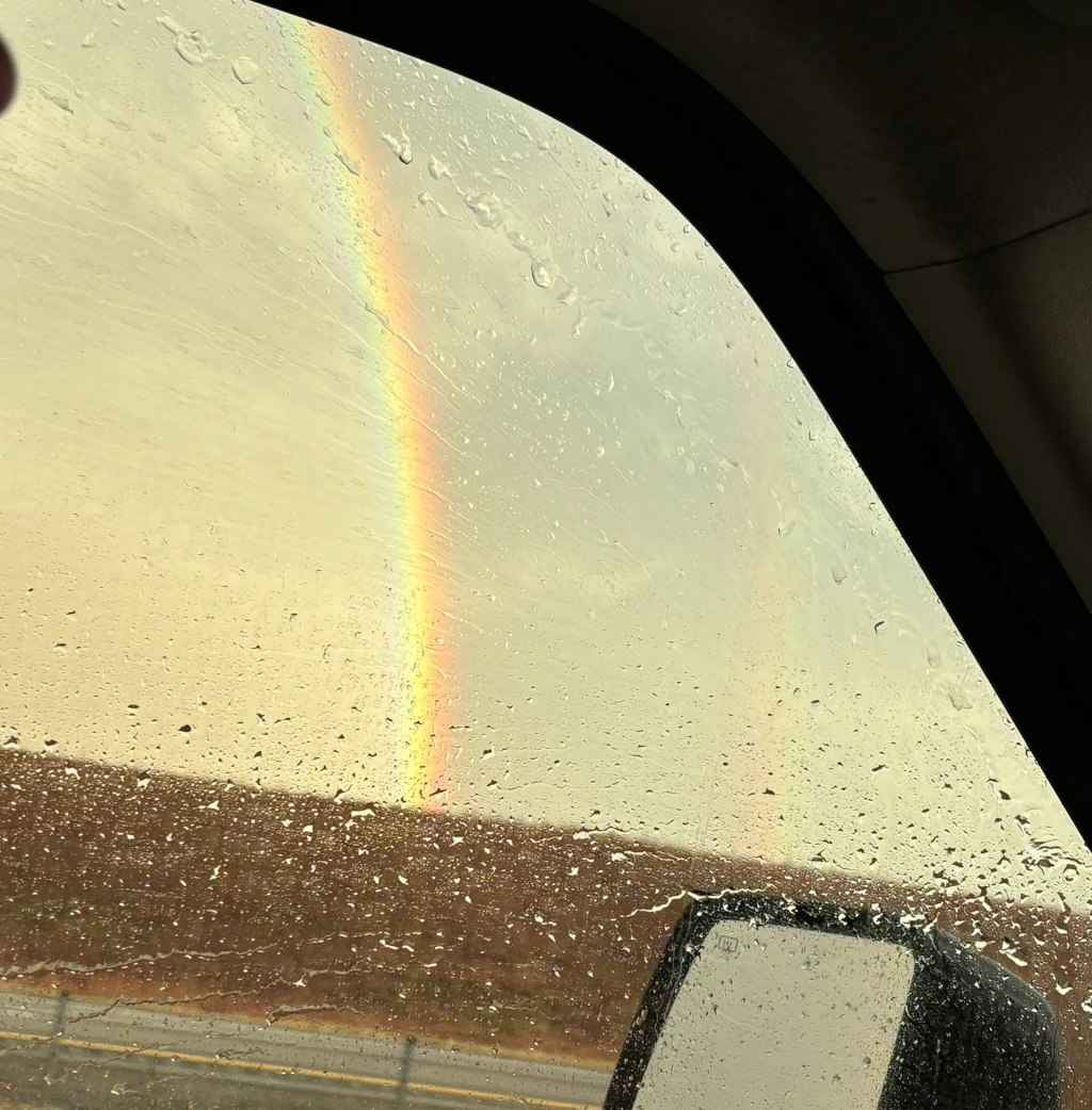 A rainbow as see from inside a car