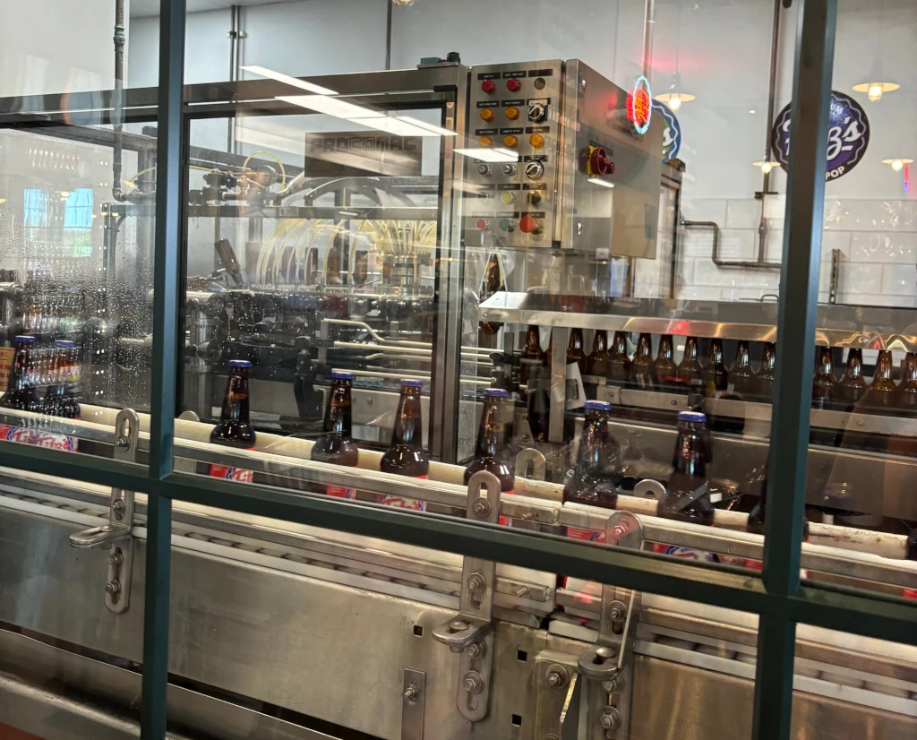 A assembly line of root beer bottles