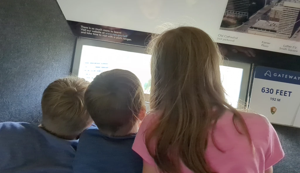 Kids looking out the window at the top of the Gateway Arch