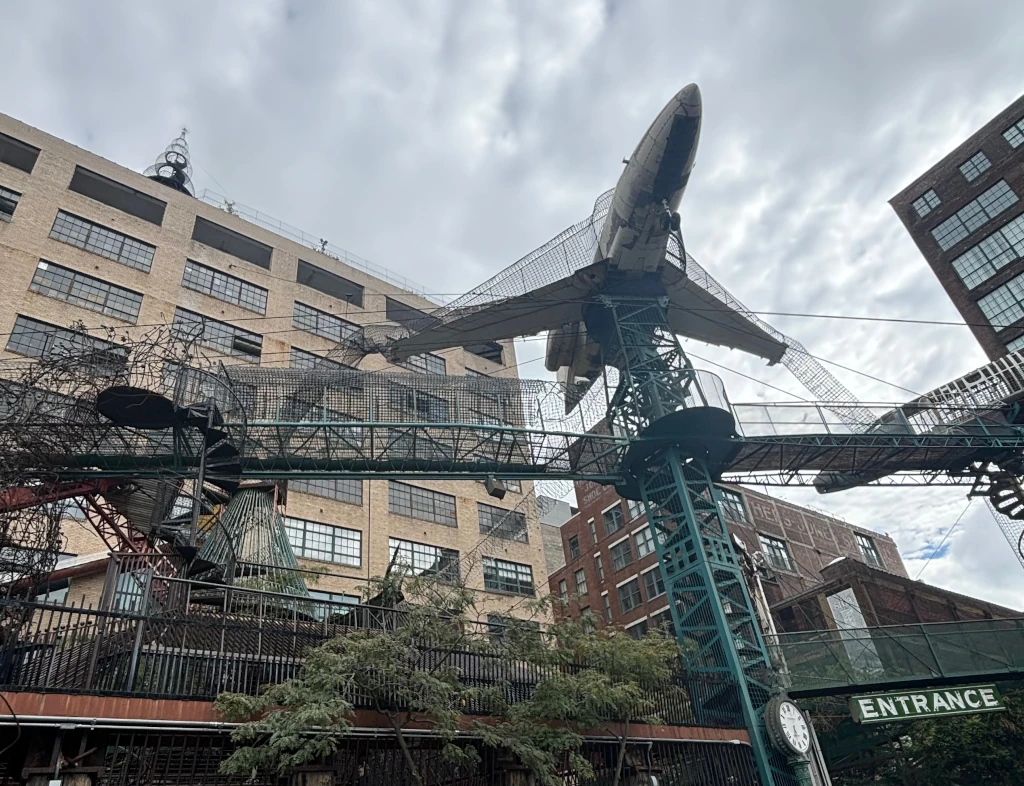 An airplane suspended over a playground