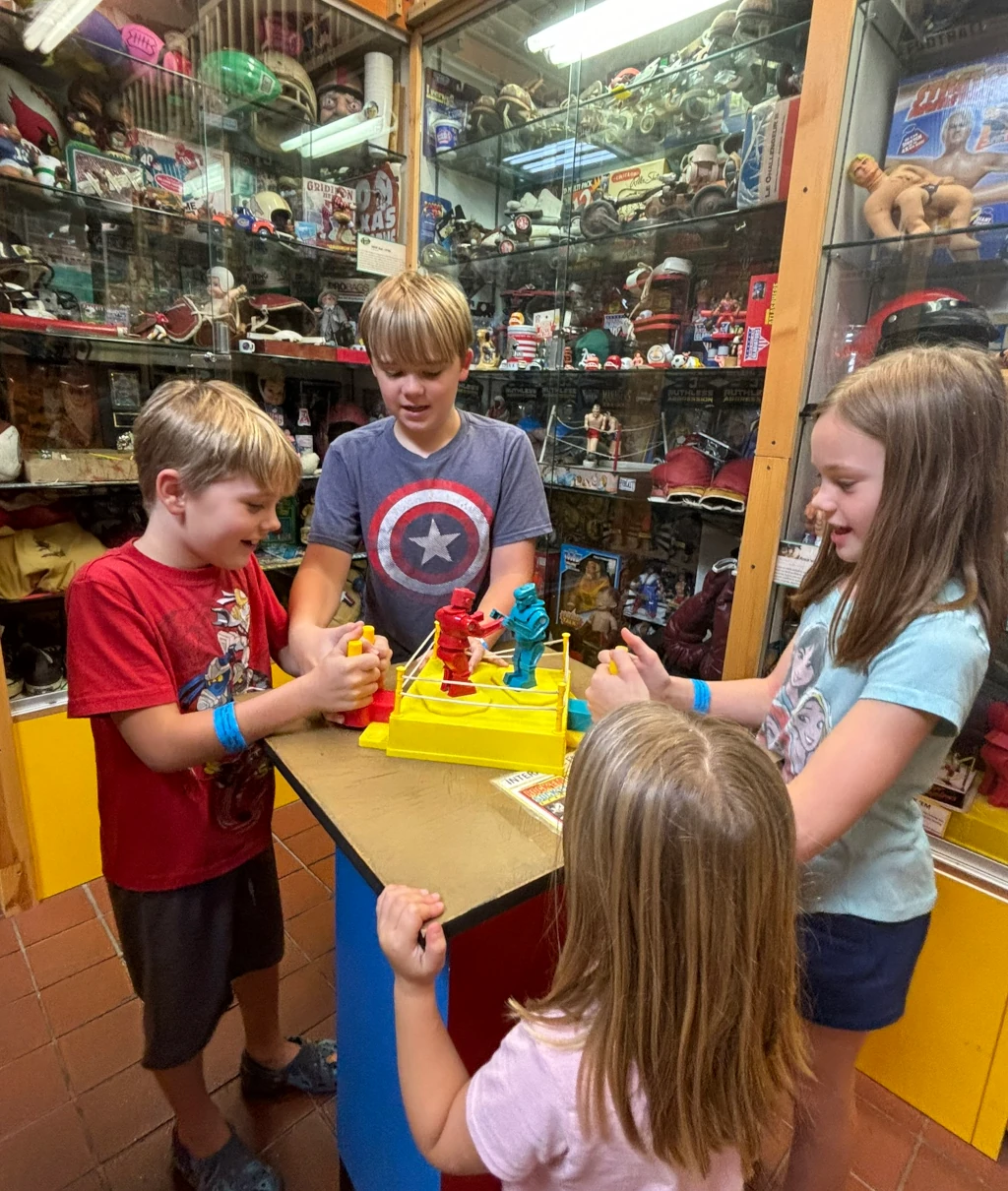 Kids playing with a rock-em-sock-em robot toy