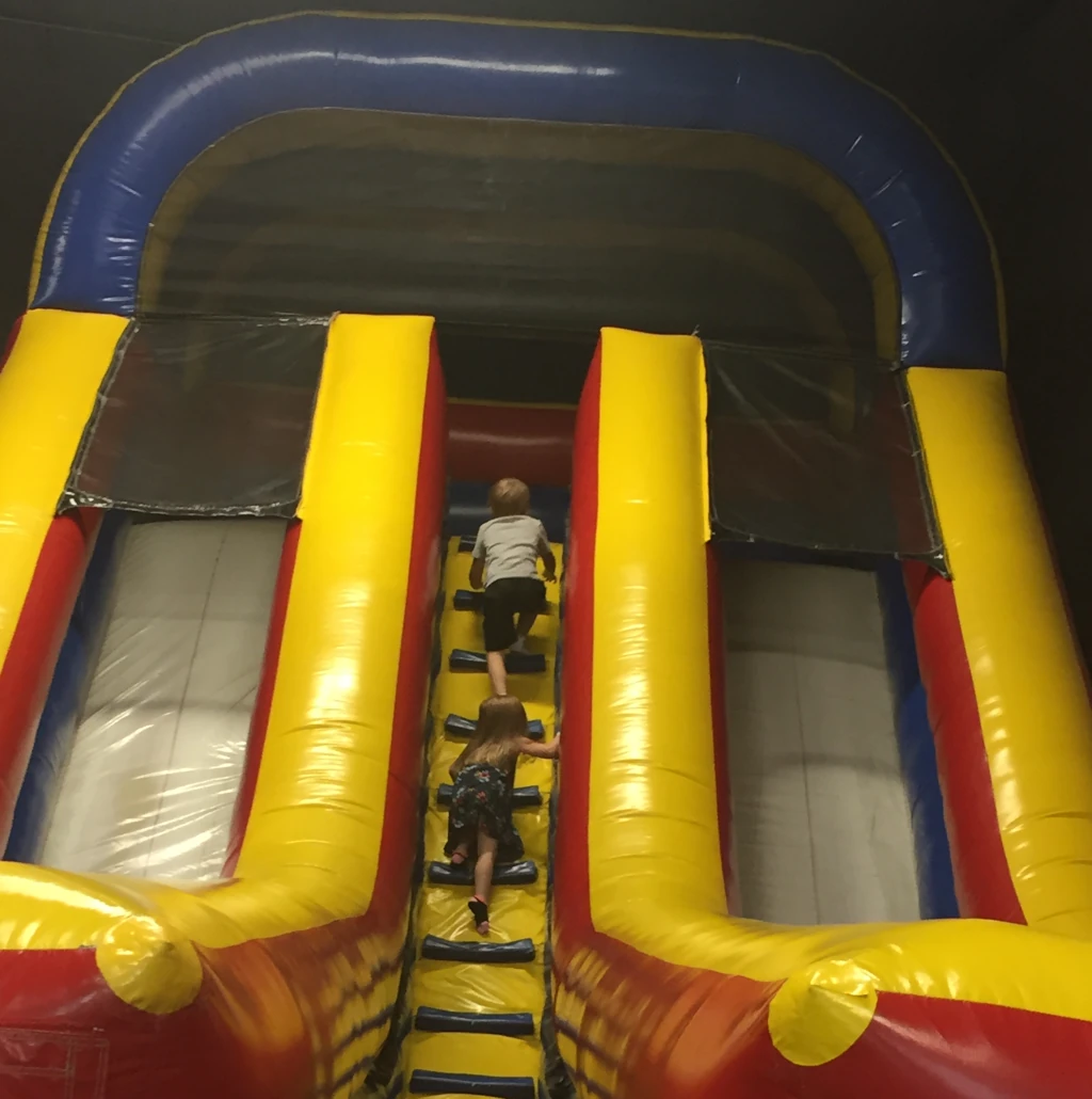 Kids climbing a bounce house