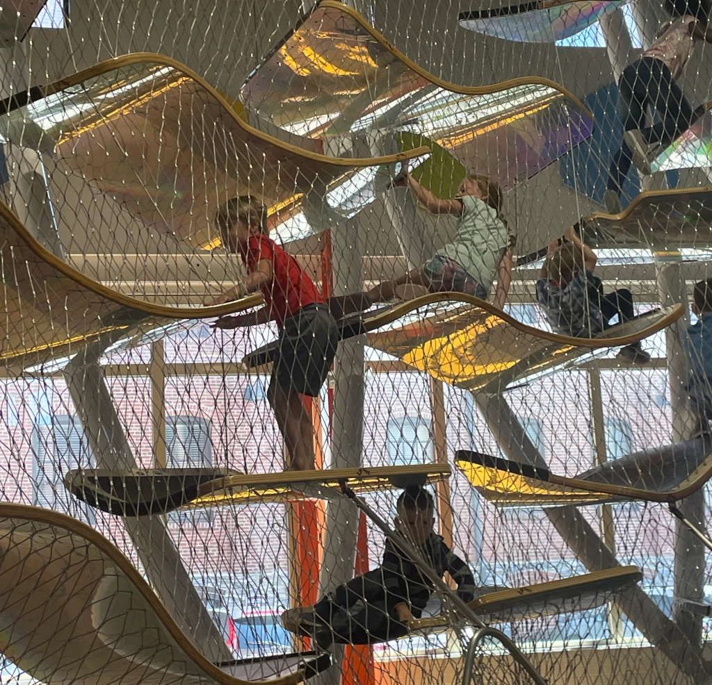 Kids climbing in a large structure