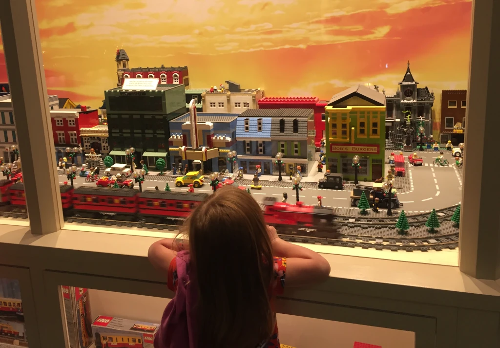 A kid looking at toy trains